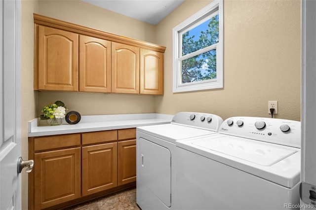 laundry area with cabinet space and independent washer and dryer