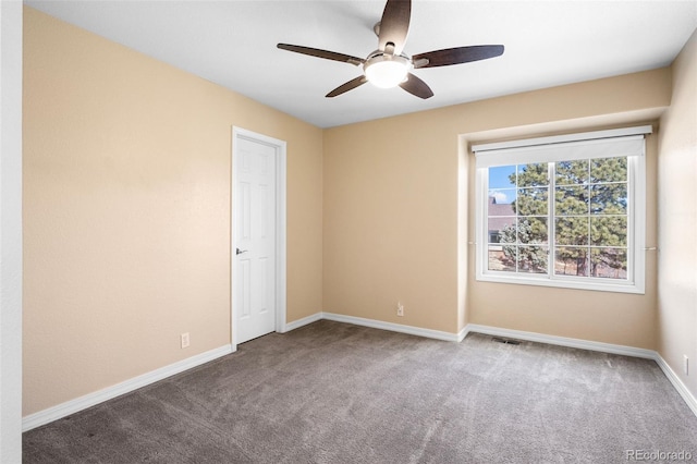 unfurnished room with visible vents, baseboards, ceiling fan, and carpet flooring