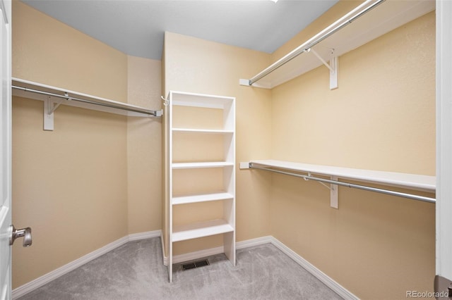 spacious closet featuring visible vents and carpet floors