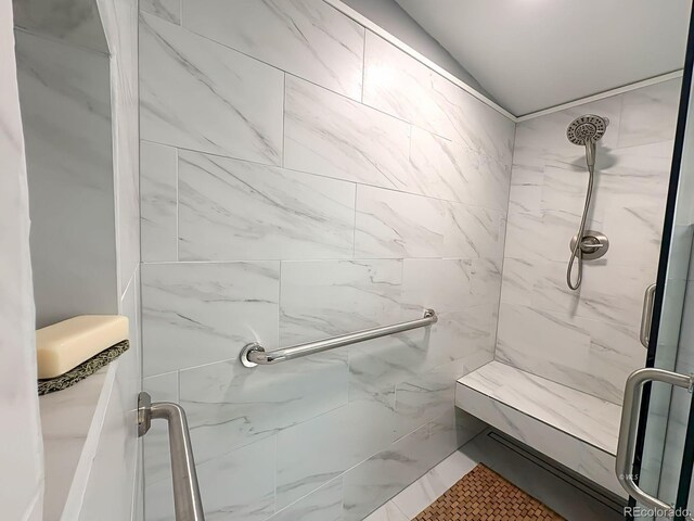 29 Granada Ct, Silver Cliff, CO 81252 - bathroom featuring a marble finish shower and vaulted ceiling
