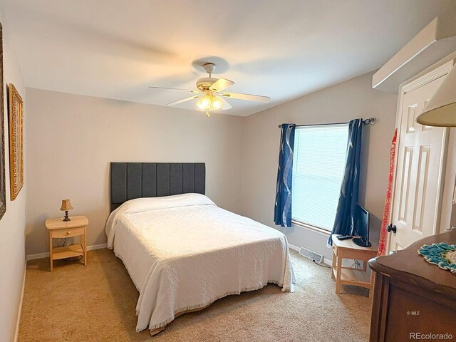 29 Granada Ct, Silver Cliff, CO 81252 - bedroom featuring light carpet, baseboards, ceiling fan, and vaulted ceiling