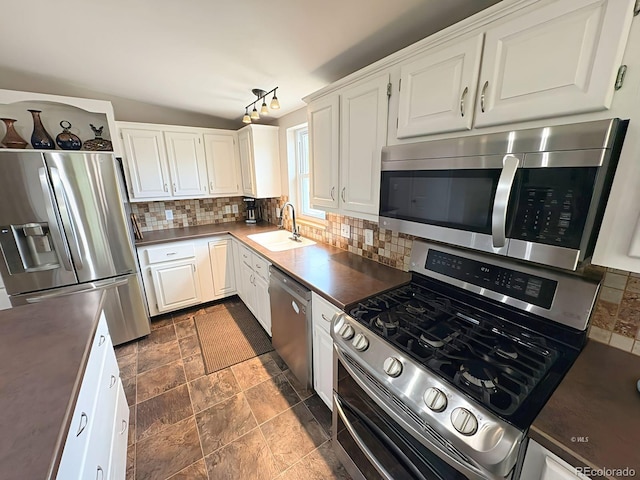 29 Granada Ct, Silver Cliff, CO 81252 - kitchen with appliances with stainless steel finishes, a sink, decorative backsplash, stone tile floors, and white cabinetry