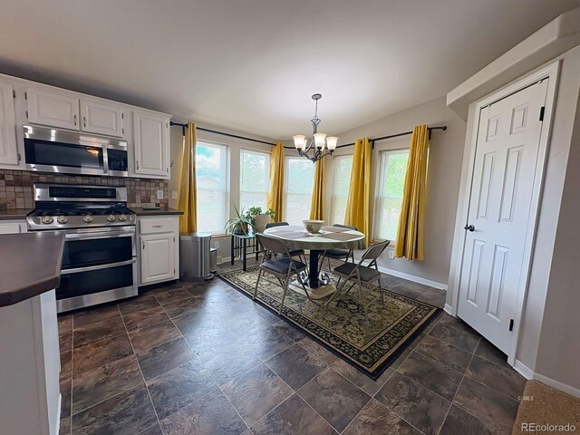 29 Granada Ct, Silver Cliff, CO 81252 - dining space with a chandelier, healthy amount of natural light, baseboards, and vaulted ceiling