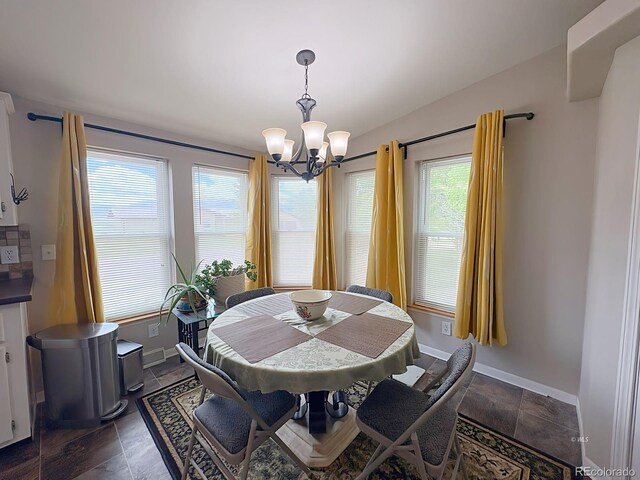 29 Granada Ct, Silver Cliff, CO 81252 - dining area featuring a chandelier, baseboards, and dark stone finish flooring