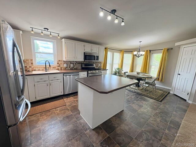 29 Granada Ct, Silver Cliff, CO 81252 - kitchen featuring appliances with stainless steel finishes, a sink, backsplash, and white cabinets