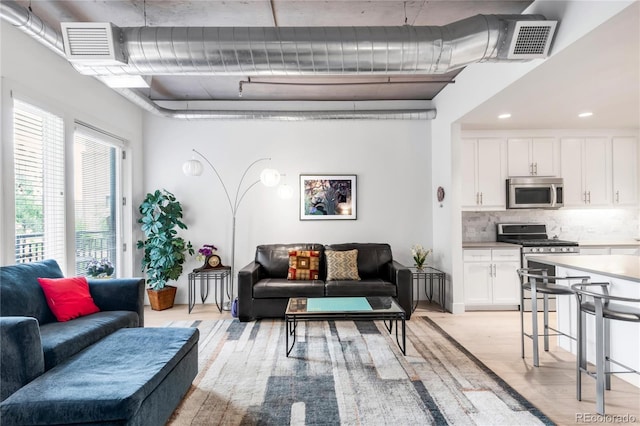 3401 Arapahoe Ave Unit 105, Boulder, CO 80303 - living room featuring light wood finished floors and recessed lighting