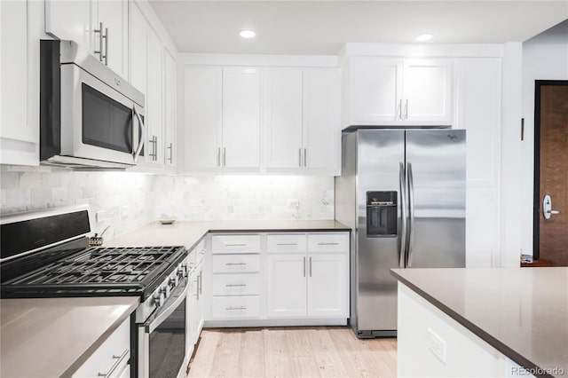 3401 Arapahoe Ave Unit 105, Boulder, CO 80303 - kitchen with stainless steel appliances, white cabinets, light wood-style flooring, backsplash, and recessed lighting