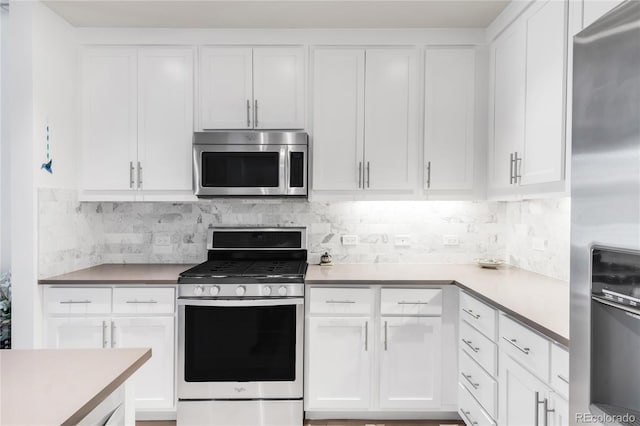 3401 Arapahoe Ave Unit 105, Boulder, CO 80303 - kitchen featuring appliances with stainless steel finishes, white cabinets, light countertops, and tasteful backsplash
