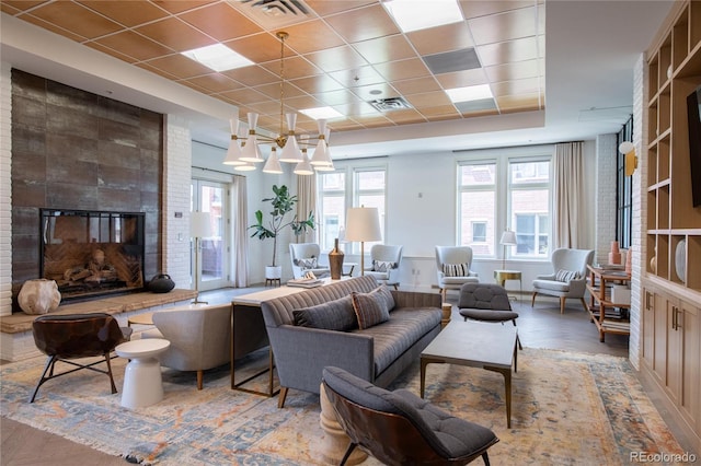 3401 Arapahoe Ave Unit 105, Boulder, CO 80303 - living area featuring a tiled fireplace and wood finished floors