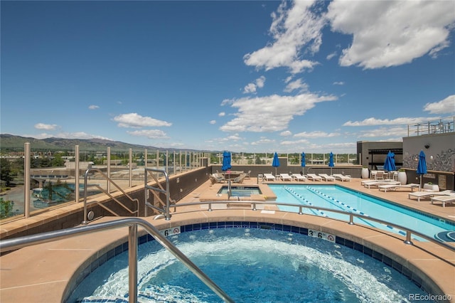 3401 Arapahoe Ave Unit 105, Boulder, CO 80303 - community pool featuring a hot tub, a mountain view, and a patio area