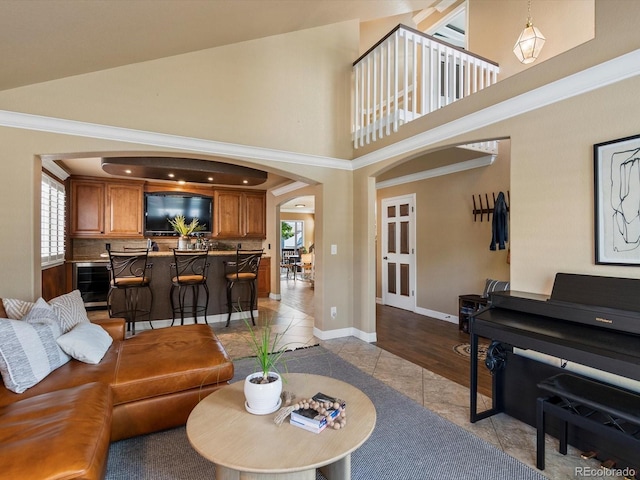 10954 W 100th Way, Broomfield, CO 80021 - living room with arched walkways, healthy amount of natural light, a towering ceiling, and french doors