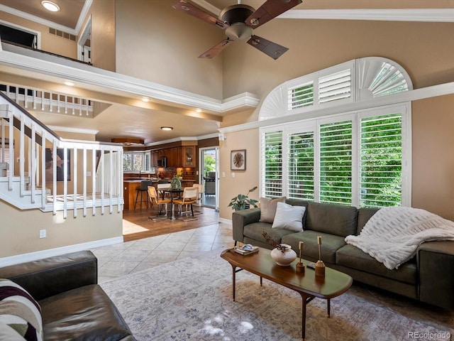 10954 W 100th Way, Broomfield, CO 80021 - living room featuring a ceiling fan, crown molding, a high ceiling, light tile patterned floors, and stairway