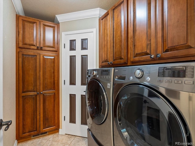 10954 W 100th Way, Broomfield, CO 80021 - laundry room featuring cabinet space, washing machine and dryer, light tile patterned floors, and ornamental molding