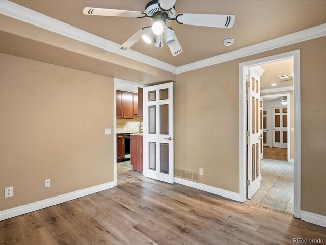 10954 W 100th Way, Broomfield, CO 80021 - spare room featuring a ceiling fan, crown molding, light wood-style floors, and a smoke detector