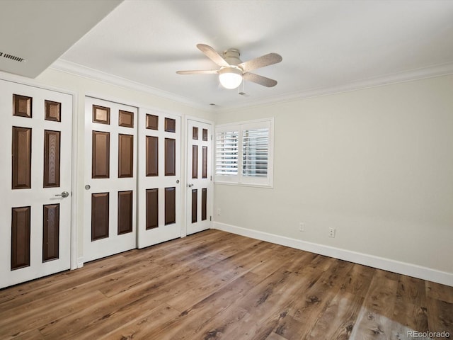 10954 W 100th Way, Broomfield, CO 80021 - unfurnished bedroom featuring crown molding, wood finished floors, and ceiling fan