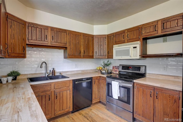 4665 Fox Rd, Cascade, CO 80809 - kitchen featuring dishwasher, white microwave, electric stove, and light countertops