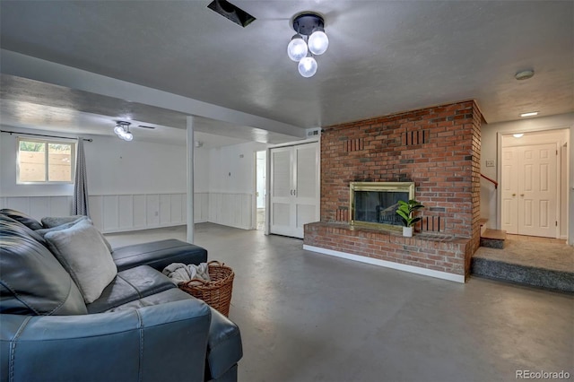 4665 Fox Rd, Cascade, CO 80809 - living area with finished concrete floors, a brick fireplace, stairway, and wainscoting
