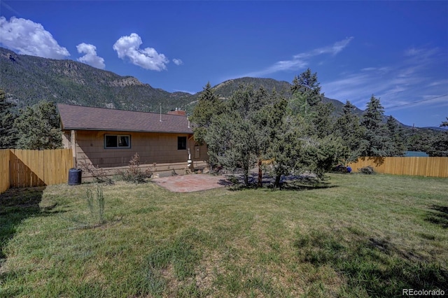 4665 Fox Rd, Cascade, CO 80809 - rear view of property featuring a fenced backyard, a mountain view, a patio area, and a chimney