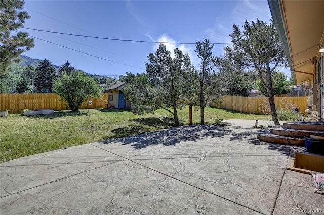 4665 Fox Rd, Cascade, CO 80809 - fenced backyard with a patio and an outbuilding