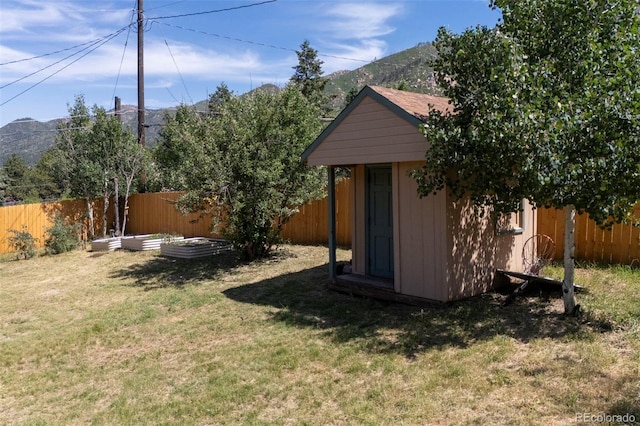 4665 Fox Rd, Cascade, CO 80809 - fenced backyard featuring a mountain view, a vegetable garden, and a storage shed