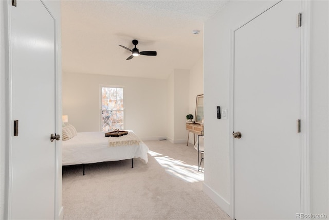 bedroom featuring light colored carpet and ceiling fan