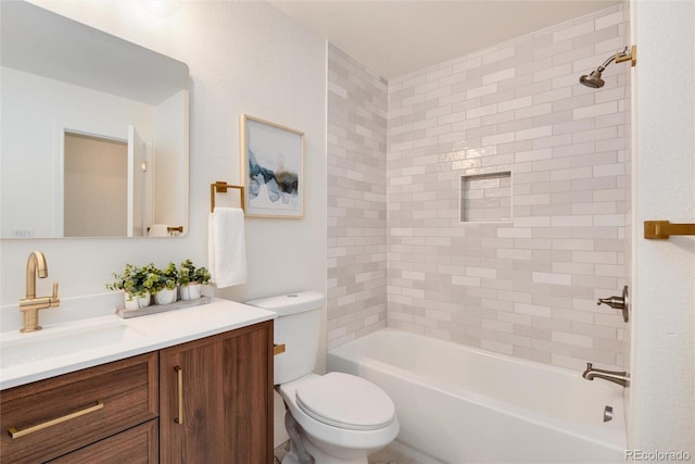 full bathroom with toilet, vanity, and tiled shower / bath