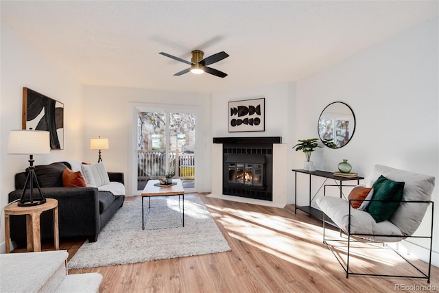 living room with wood-type flooring and ceiling fan