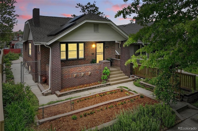 3611 N Vine St, Denver, CO 80205 - bungalow featuring brick siding, a chimney, and a shingled roof