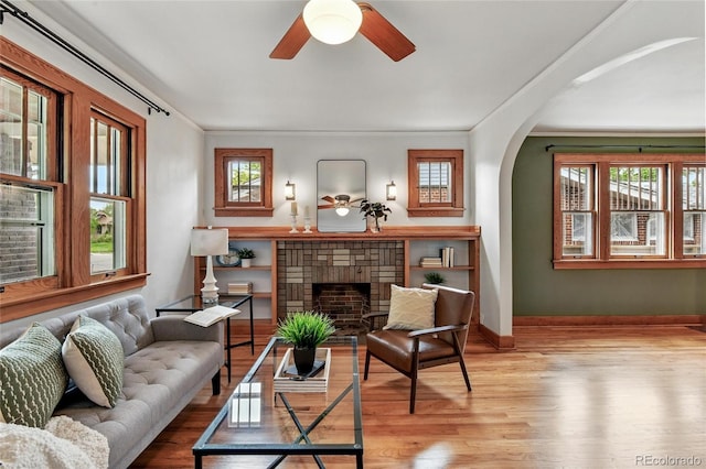 3611 N Vine St, Denver, CO 80205 - sitting room featuring arched walkways, a ceiling fan, wood finished floors, crown molding, and baseboards