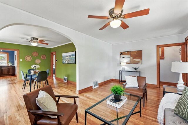 3611 N Vine St, Denver, CO 80205 - living area featuring ceiling fan, arched walkways, light wood-type flooring, baseboards, and ornamental molding