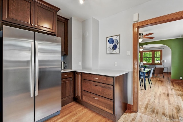3611 N Vine St, Denver, CO 80205 - kitchen with freestanding refrigerator, a ceiling fan, light wood-type flooring, light countertops, and arched walkways