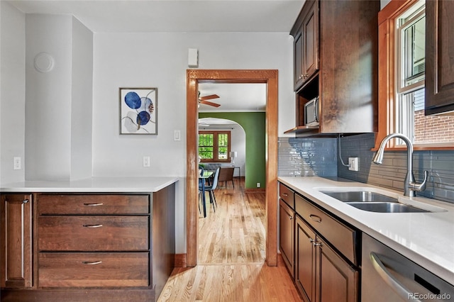3611 N Vine St, Denver, CO 80205 - kitchen featuring dishwasher, a sink, light wood-style floors, light countertops, and tasteful backsplash