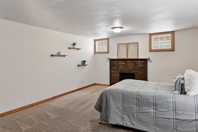 3611 N Vine St, Denver, CO 80205 - bedroom with carpet floors, baseboards, a textured ceiling, and a brick fireplace