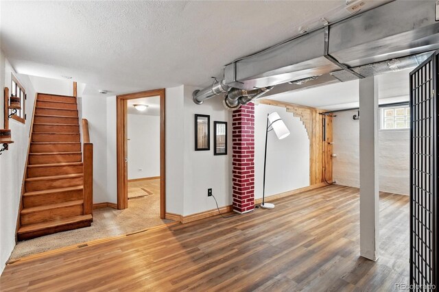 3611 N Vine St, Denver, CO 80205 - basement featuring wood finished floors, stairs, baseboards, and a textured ceiling