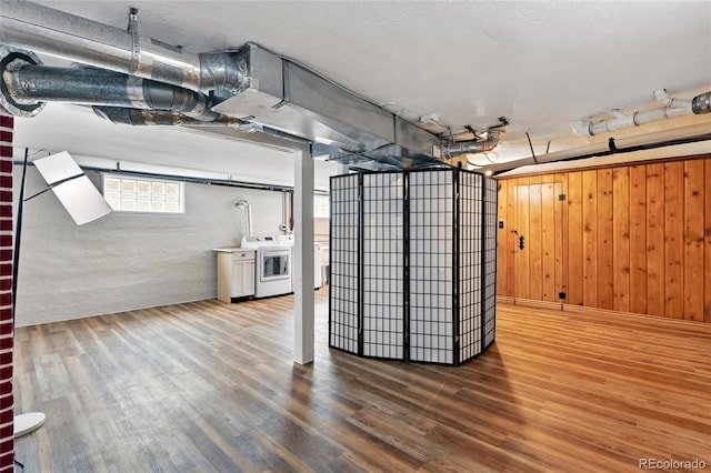 3611 N Vine St, Denver, CO 80205 - below grade area with wood finished floors, wooden walls, and washer and clothes dryer
