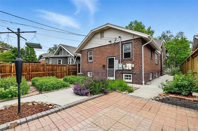 3611 N Vine St, Denver, CO 80205 - rear view of house featuring brick siding, a patio, and driveway