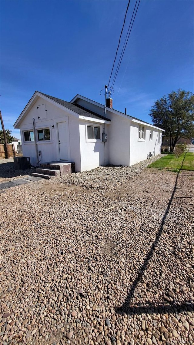 rear view of house featuring cooling unit