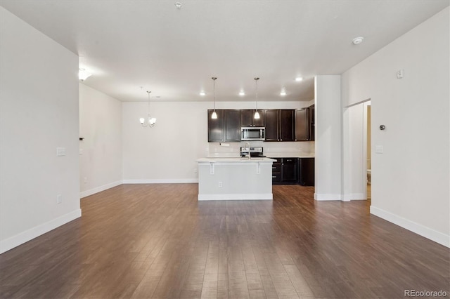 unfurnished living room featuring dark hardwood / wood-style floors and a notable chandelier