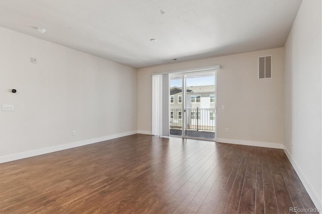 unfurnished room with dark wood-type flooring