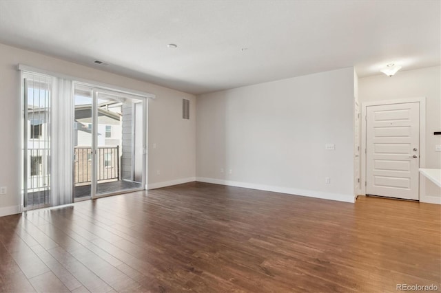 spare room with hardwood / wood-style floors