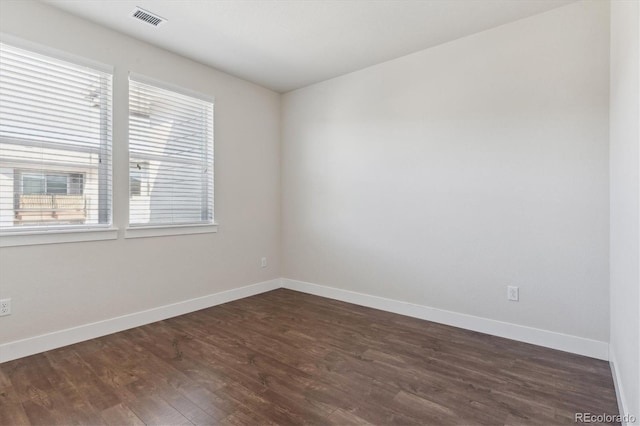 empty room with dark wood-type flooring