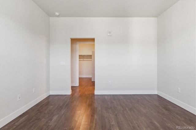 spare room with dark hardwood / wood-style flooring