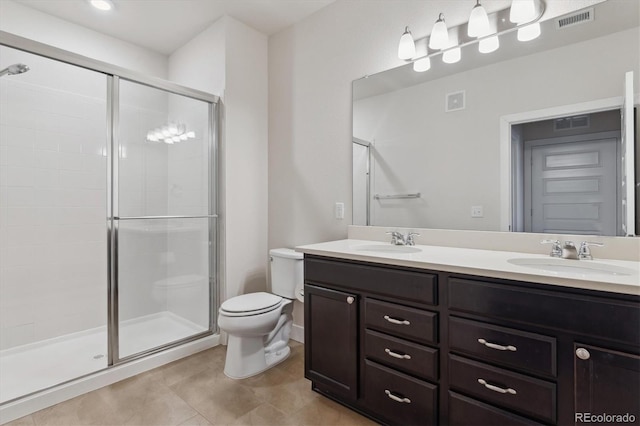 bathroom with vanity, toilet, tile patterned flooring, and a shower with door