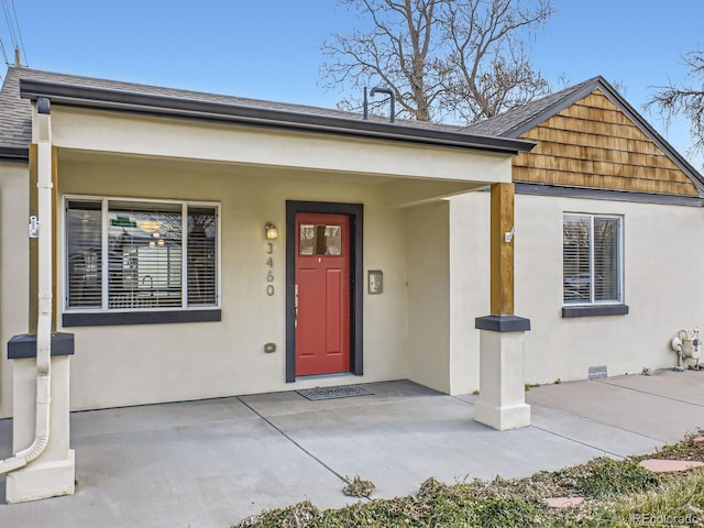 view of exterior entry with a porch