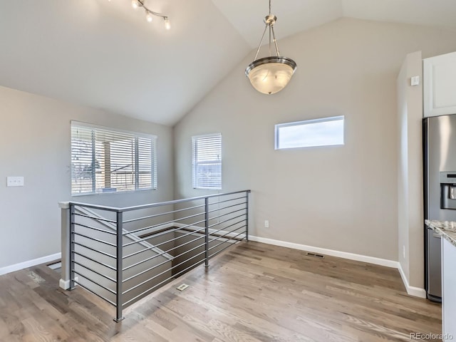 interior space with lofted ceiling and wood-type flooring