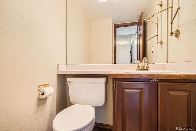 bathroom with vanity, vaulted ceiling, and toilet