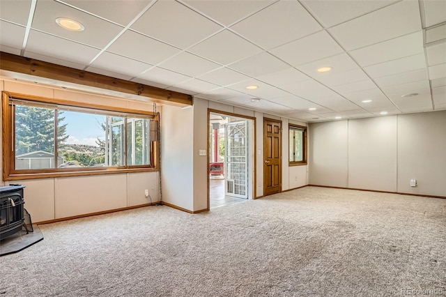 interior space with carpet floors and a wood stove