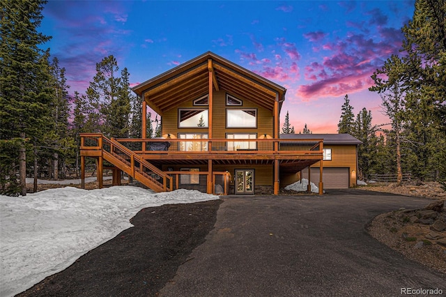 423 Prunes Pl, Fairplay, CO 80440 - chalet / cabin with a deck, asphalt driveway, a garage, stairway, and french doors