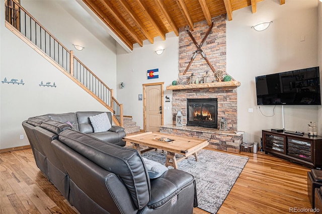 423 Prunes Pl, Fairplay, CO 80440 - living area with high vaulted ceiling, wood ceiling with exposed beams, light wood finished floors, stairs, and a fireplace
