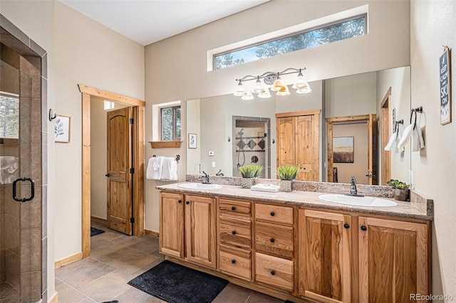 423 Prunes Pl, Fairplay, CO 80440 - bathroom featuring a stall shower, double vanity, baseboards, and a high ceiling